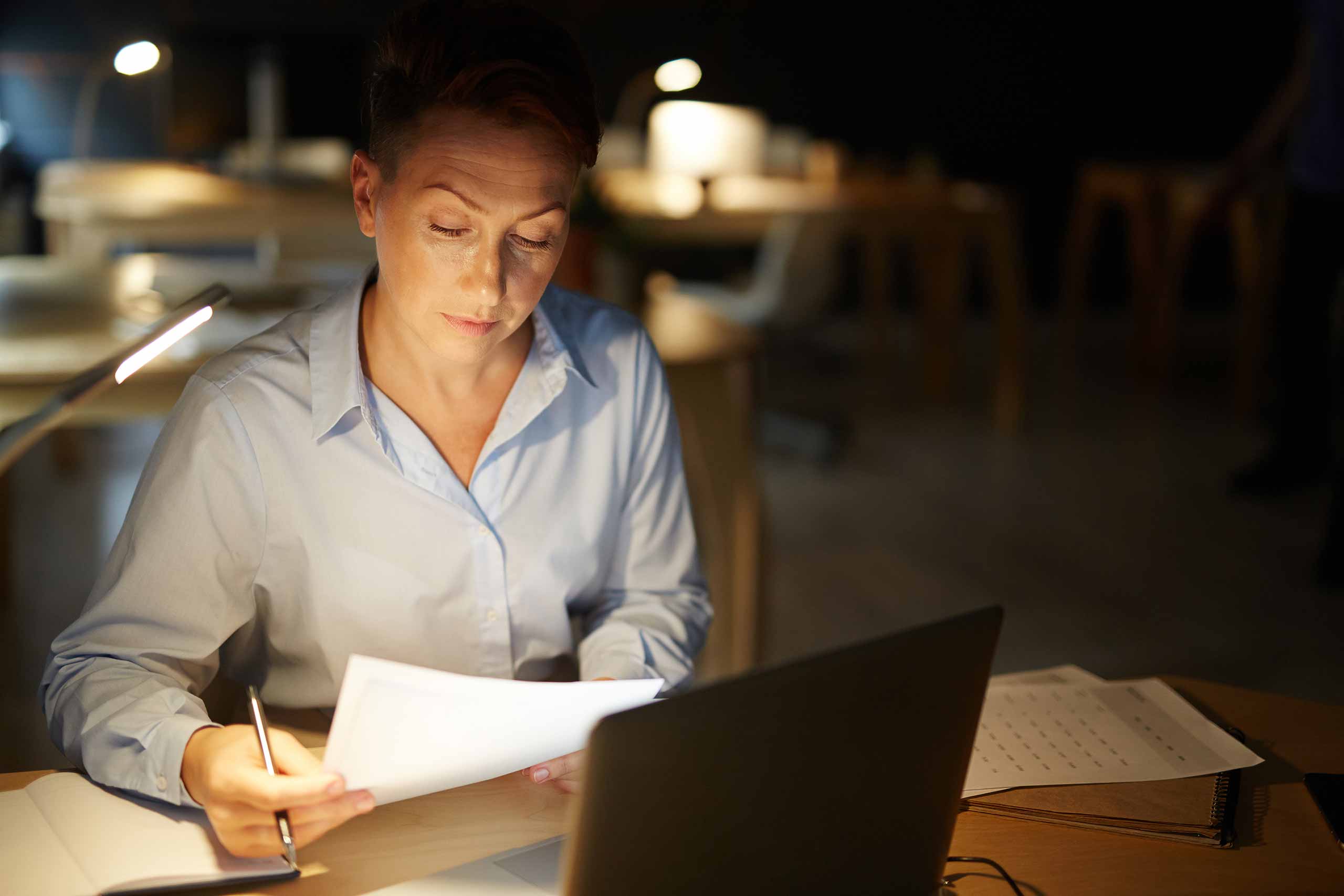 Woman studying late at night, she probably wishes she was in bed :(